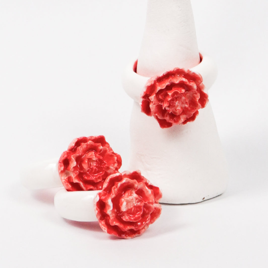 red-peony-ceramic-ring-Leap-And-Linger-Product-Rings-by-Nomi-Bui-With-Hand-1st-Angle