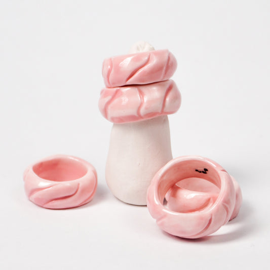 tires-pink-jump-ceramic-ring-Leap-And-Linger-Product-Rings-by-Nomi-Bui-With-Hand-1st-Angle