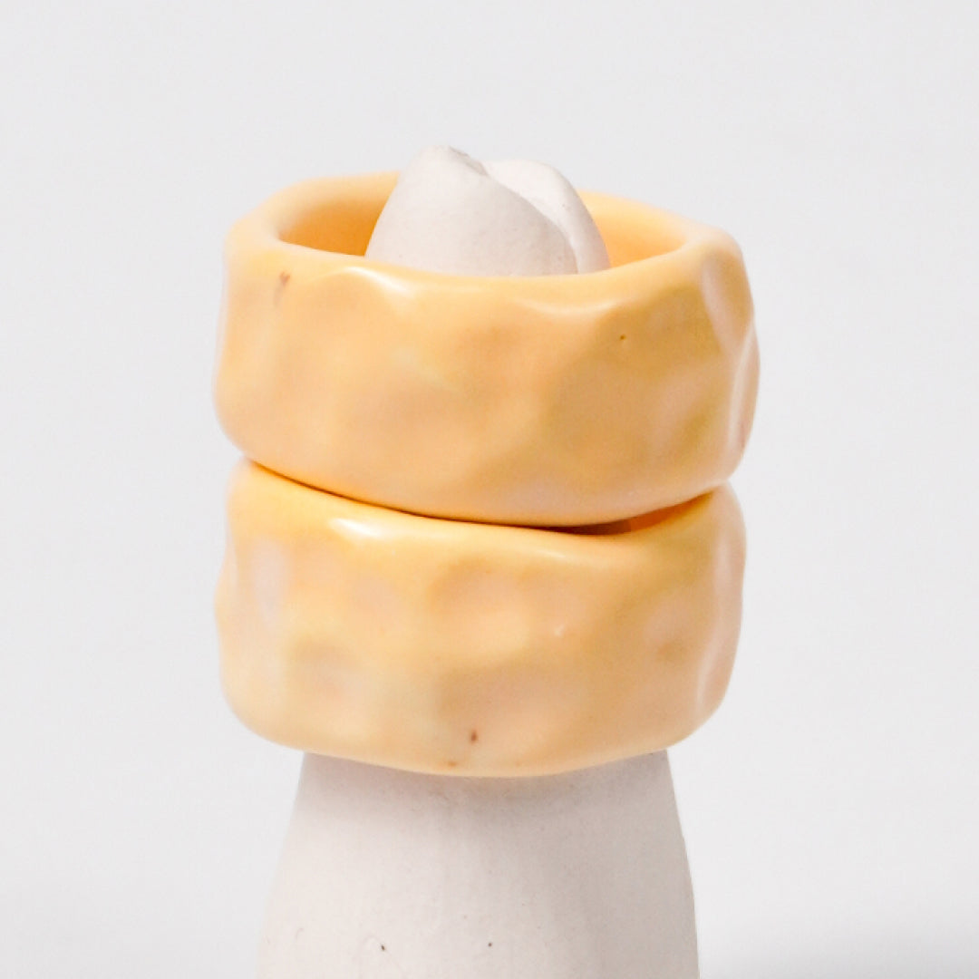 peace-tender-yellow-ceramic-ring-Leap-And-Linger-Product-Rings-by-Nomi-Bui-With-Stand-2nd-Angle_55fb9097-4f7d-4163-80c6-bc97c85468ce