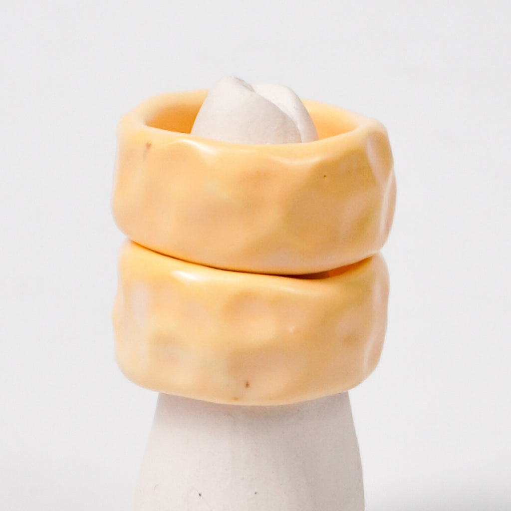peace-tender-yellow-porcelain-ring-Leap-And-Linger-Product-Rings-by-Nomi-Bui-With-Stand-2nd-Angle_55fb9097-4f7d-4163-80c6-bc97c85468ce