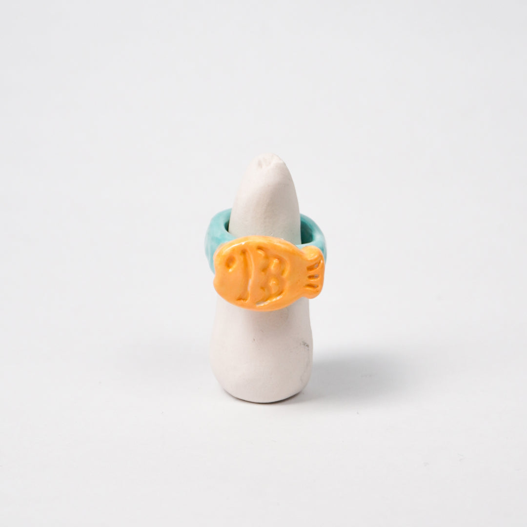 taiyaki-scuba-blue-ceramic-ring-Leap-And-Linger-Product-Rings-by-Nomi-Bui-With-Stand-1st-Angle