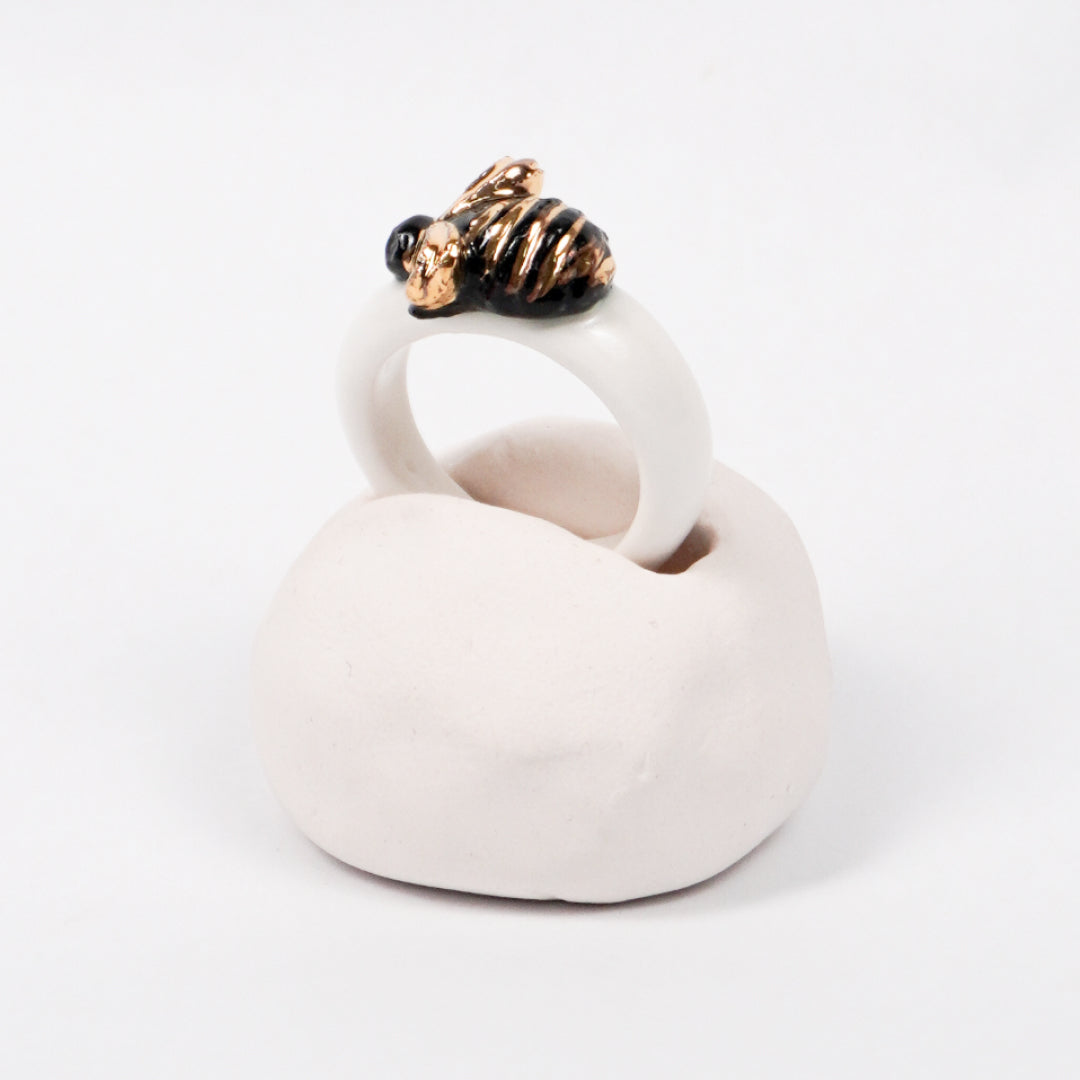 the-endless-flower-garden-bee-edition-with-24k-gold-ceramic-ring-Leap-And-Linger-Product-Rings-by-Nomi-Bui-With-Hand-1st-Angle