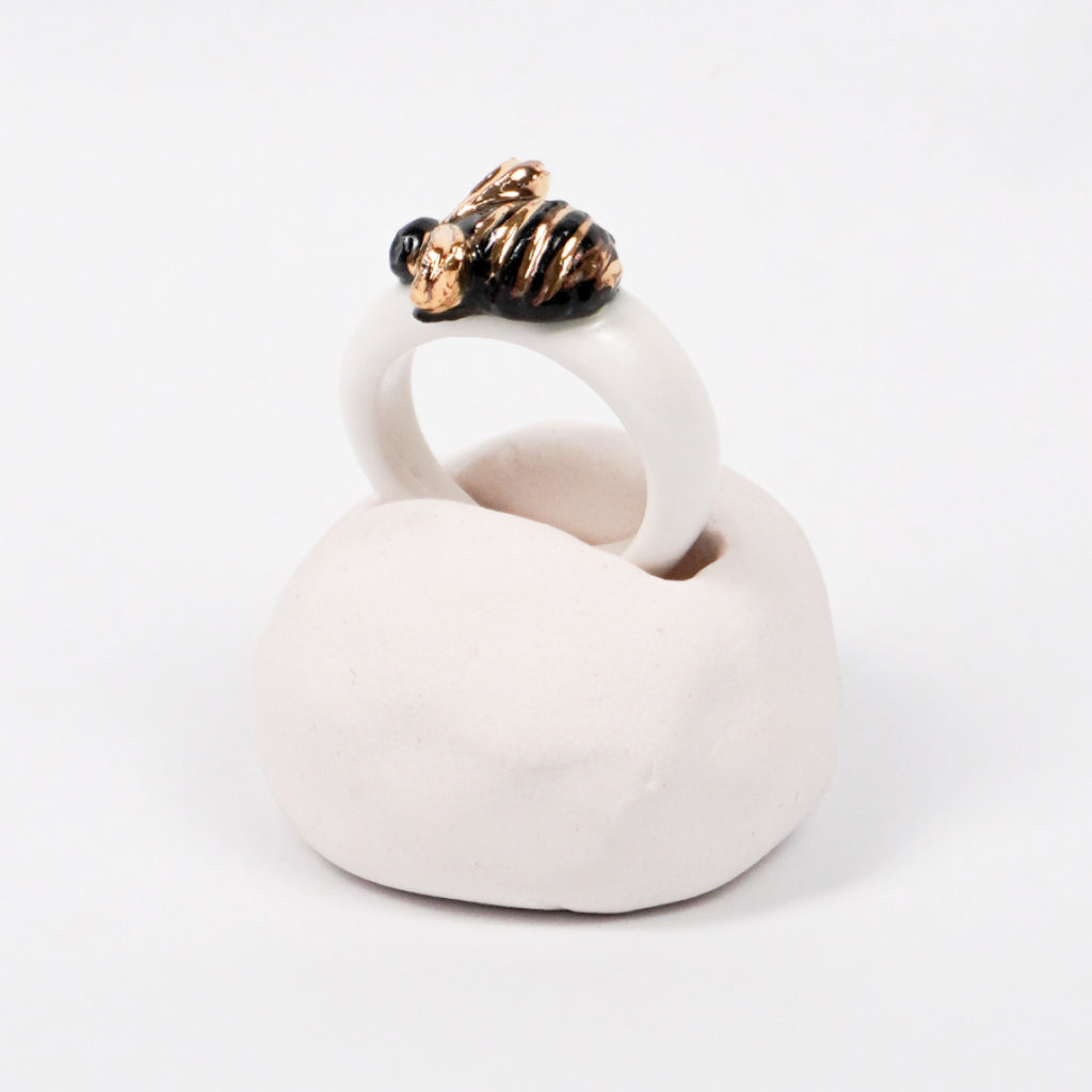 the-endless-flower-garden-bee-edition-with-24k-gold-porcelain-ring-Leap-And-Linger-Product-Rings-by-Nomi-Bui-With-Hand-1st-Angle