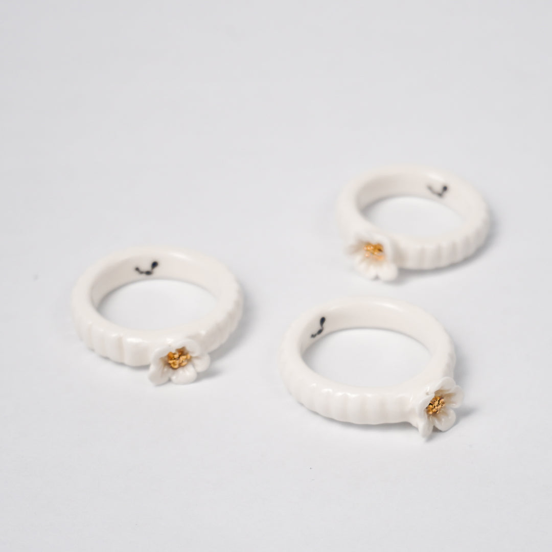 the-endless-flower-garden-delicat-edition-with-24k-gold-ceramic-ring-Leap-And-Linger-Product-Rings-by-Nomi-Bui-With-Stand-1st-Angle