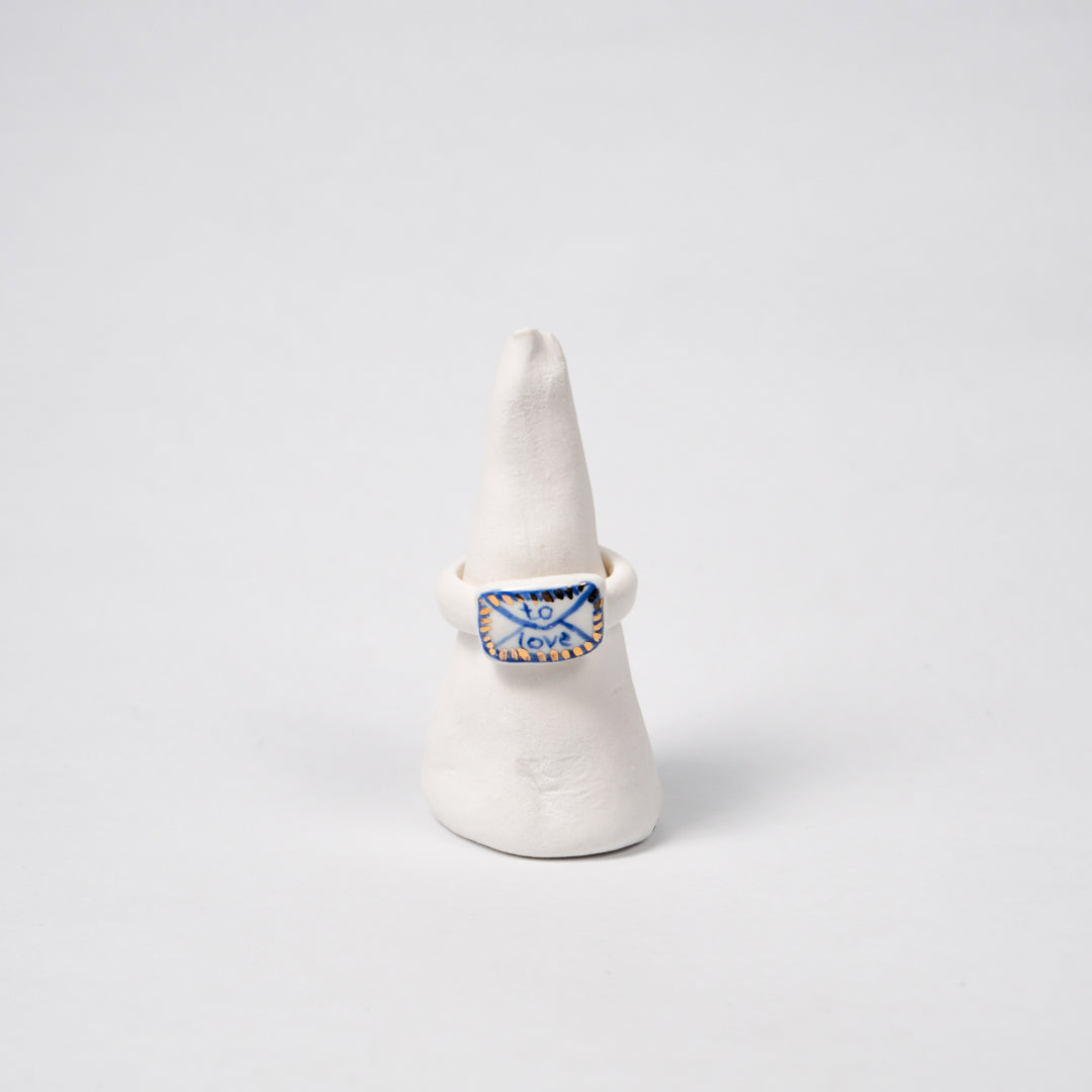 the-notebook-edition-with-24k-gold-porcelain-ring-Leap-And-Linger-Product-Rings-by-Nomi-Bui-With-Stand-1st-Angle