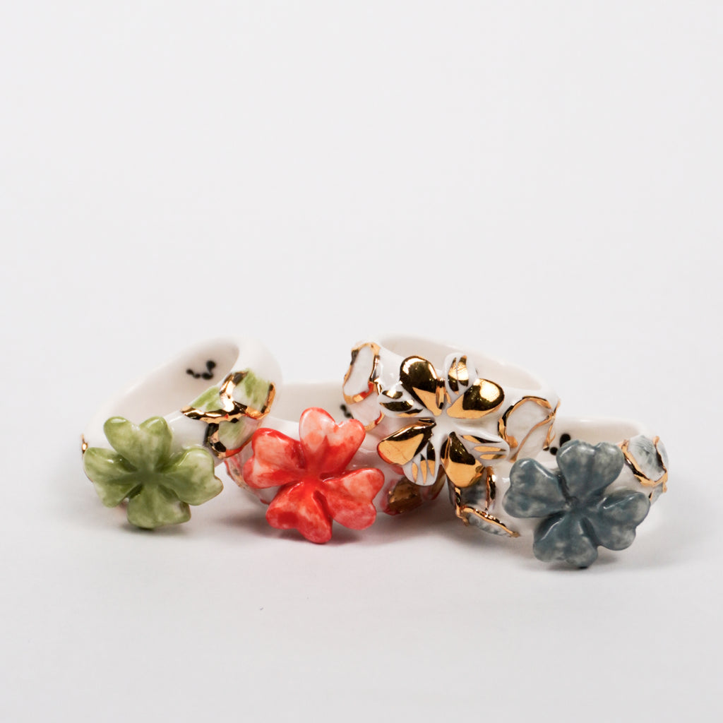 trefle-doux-carambolier-d-or-massif-edition-with-24k-gold-porcelain-ring-Leap-And-Linger-Product-Rings-by-Nomi-Bui-With-Hand-1st-Angle