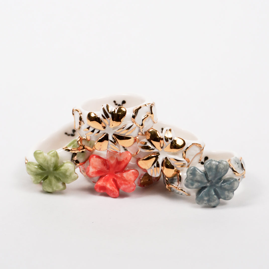 trefle-doux-d-or-edition-with-24k-gold-porcelain-ring-Leap-And-Linger-Product-Rings-by-Nomi-Bui-With-Hand-1st-Angle-1