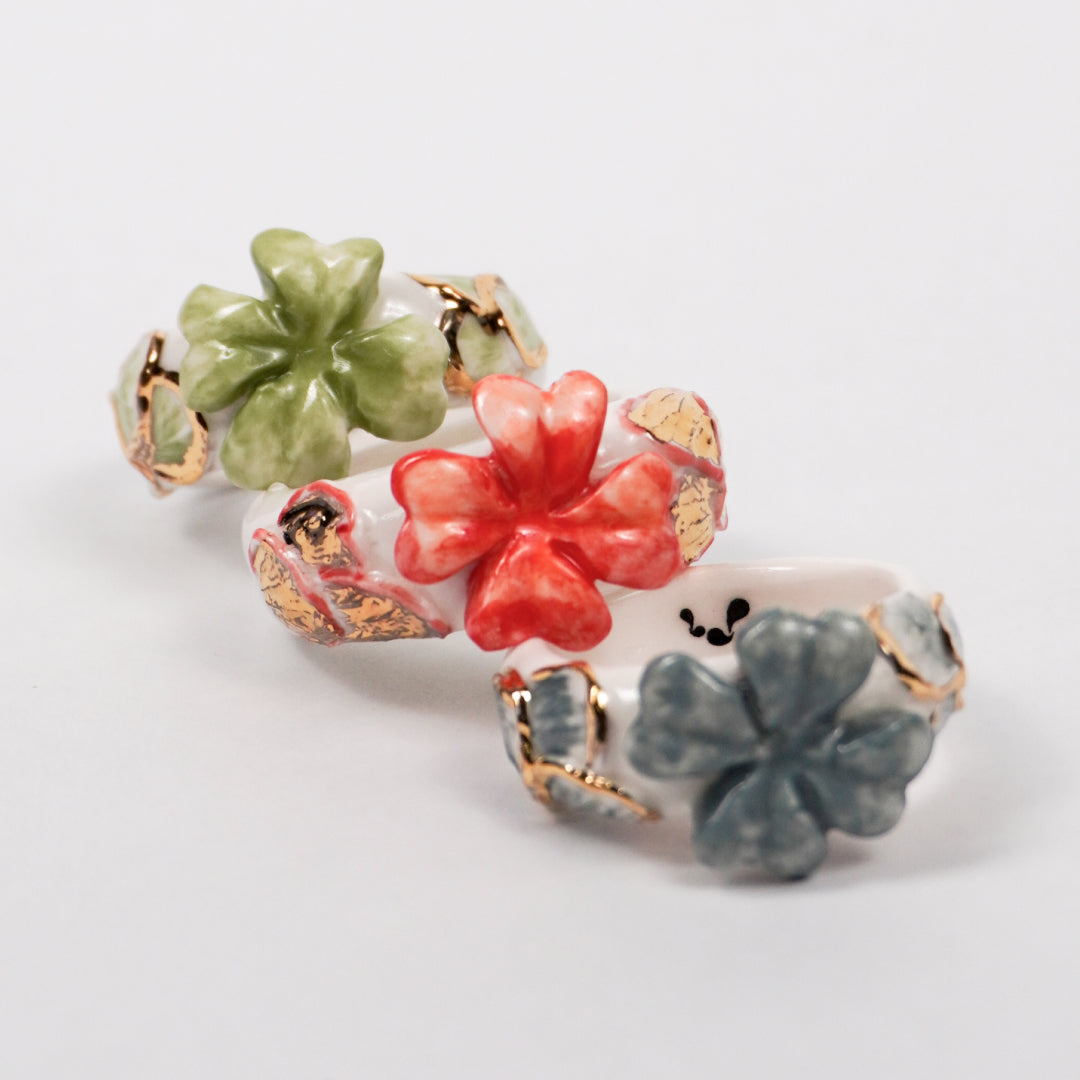 trefle-doux-le-phenix-en-flammes-edition-with-24k-gold-porcelain-ring-Leap-And-Linger-Product-Rings-by-Nomi-Bui-With-Hand-1st-Angle