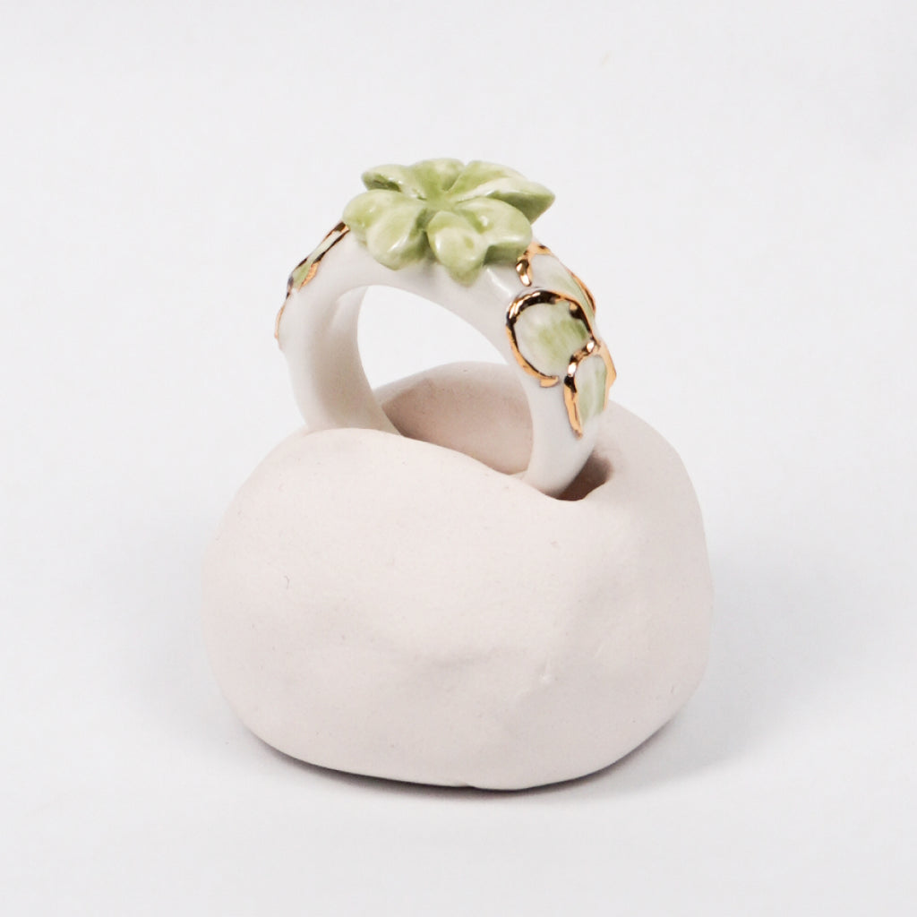 trefle-doux-princesse-edition-with-24k-gold-ceramic-ring-Leap-And-Linger-Product-Rings-by-Nomi-Bui-With-Hand-1st-Angle