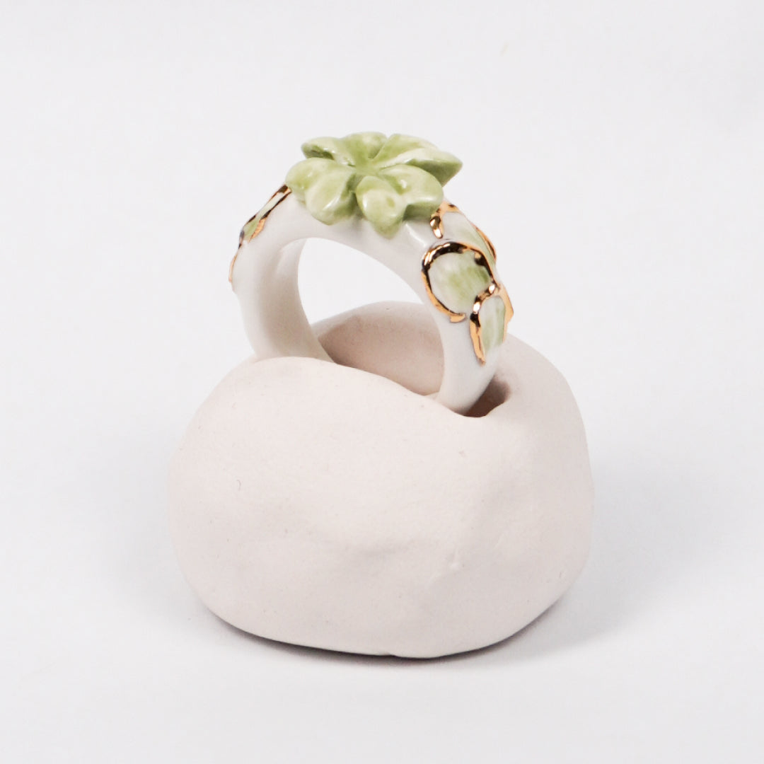trefle-doux-princesse-edition-with-24k-gold-ceramic-ring-Leap-And-Linger-Product-Rings-by-Nomi-Bui-With-Hand-1st-Angle